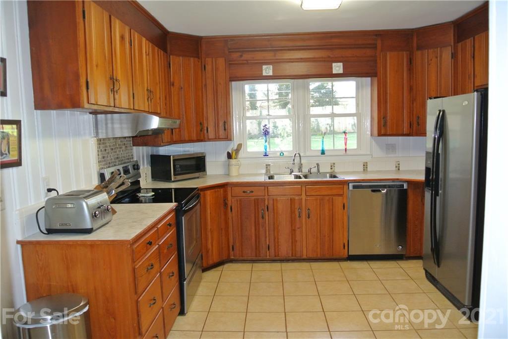 173 Tanner Street Rutherfordton, NC 28139 - Photo 7 of 25 a kitchen with stainless steel appliances granite countertop a sink stove and refrigerator