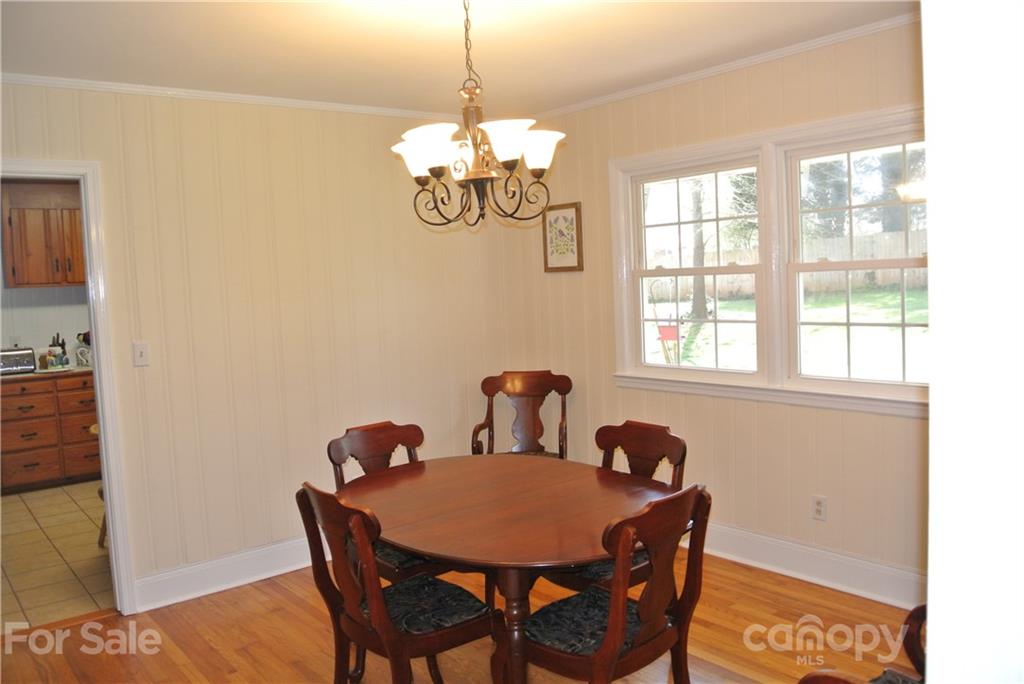 173 Tanner Street Rutherfordton, NC 28139 - Photo 10 of 25 a view of a dining room with furniture wooden floor and a chandelier