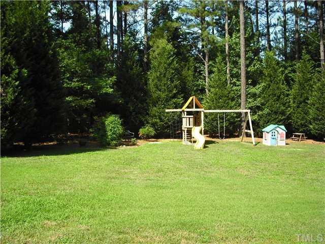 6836 Cool Pond Road Raleigh, NC 27613 - Photo 12 of 12 a house view with a sitting space and garden