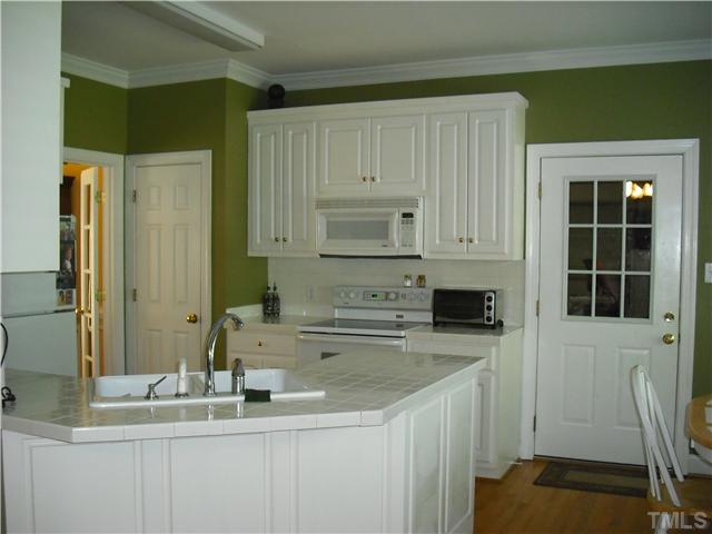 6836 Cool Pond Road Raleigh, NC 27613 - Photo 3 of 12 a kitchen with stainless steel appliances a sink stove and cabinets