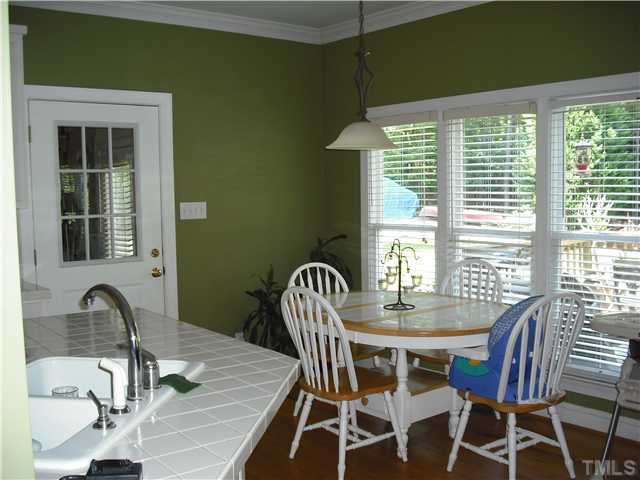 6836 Cool Pond Road Raleigh, NC 27613 - Photo 4 of 12 a dining room with furniture window and outside view