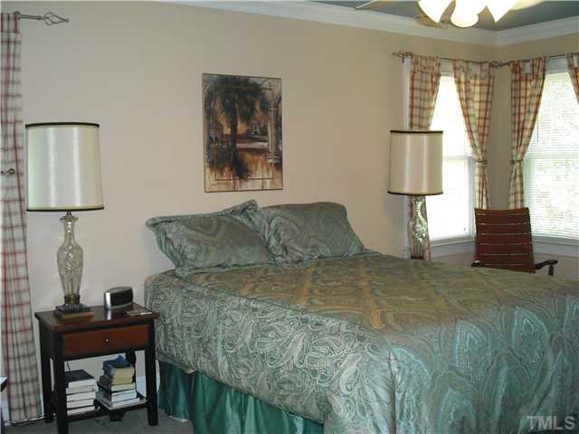 6836 Cool Pond Road Raleigh, NC 27613 - Photo 5 of 12 a bed sitting in a bedroom next to a window