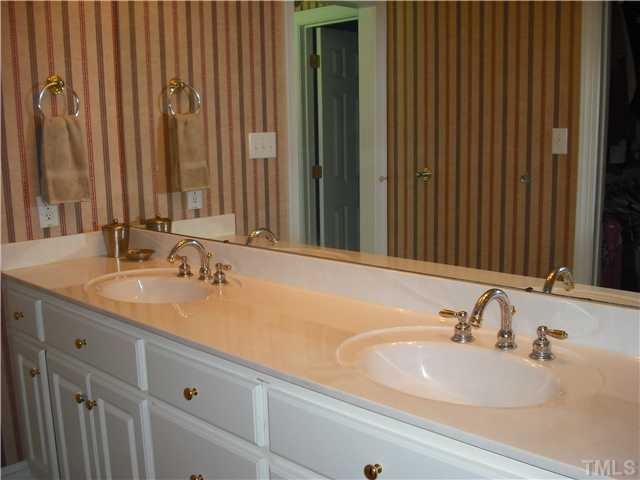 6836 Cool Pond Road Raleigh, NC 27613 - Photo 6 of 12 a bathroom with a double vanity sink and a mirror