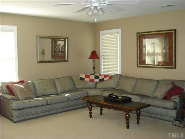 6836 Cool Pond Road Raleigh, NC 27613 - Photo 9 of 12 a living room with furniture and a chandelier