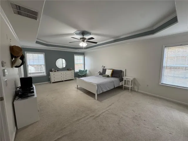 a living room with furniture and a ceiling fan