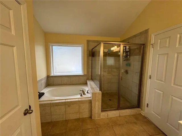 a bathroom with a bathtub and shower
