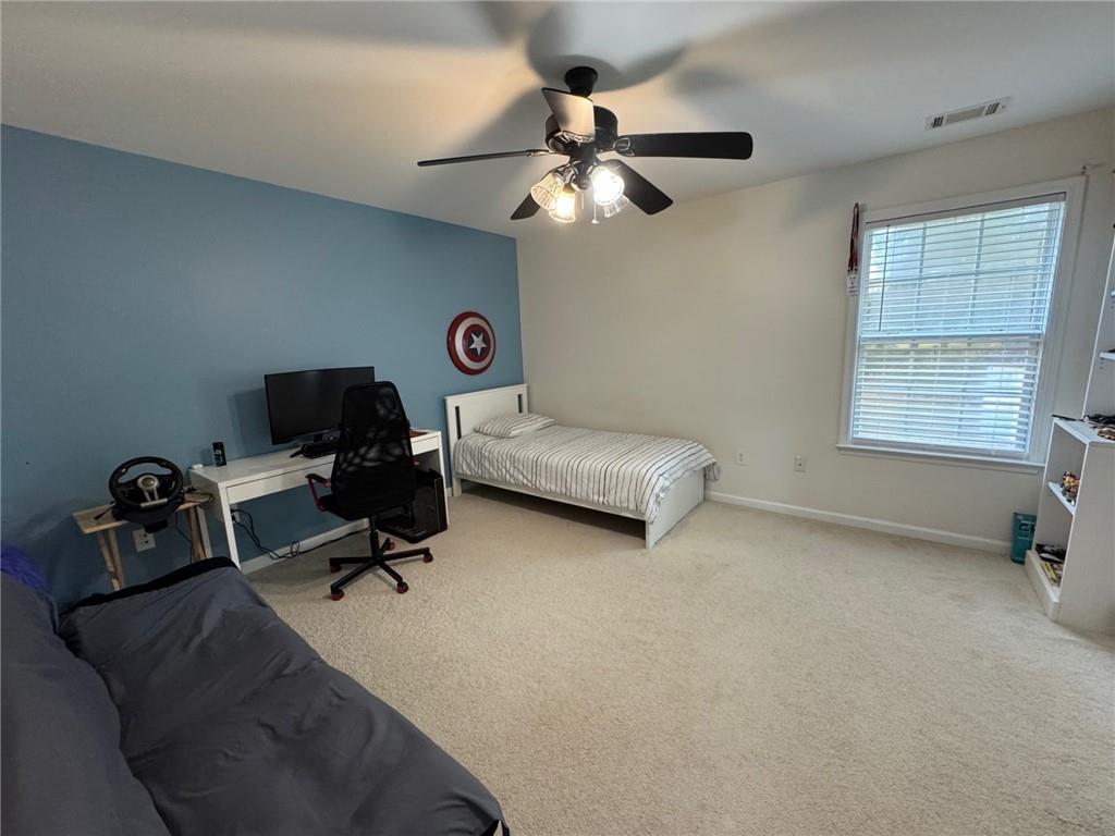 524 King Street Suwanee, GA 30024 - Photo 16 of 23 a bedroom with furniture and a ceiling fan
