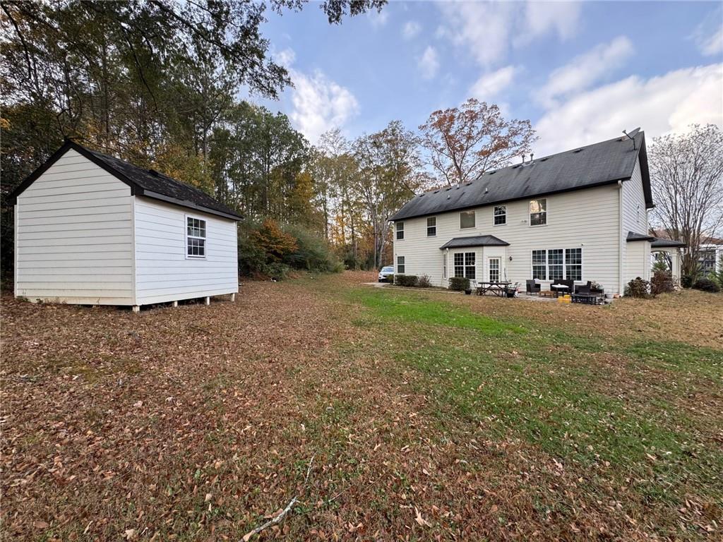 524 King Street Suwanee, GA 30024 - Photo 20 of 23 a view of a white house that has a small yard and large trees
