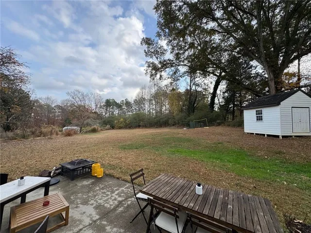 a view of a backyard with sitting area