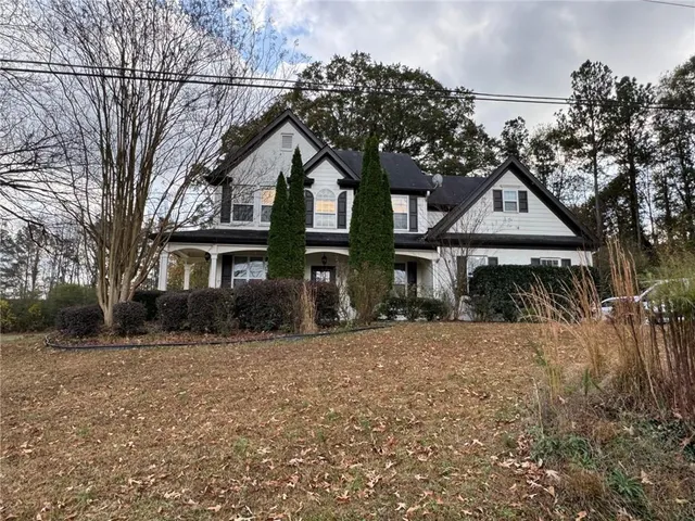 a front view of a house with a yard