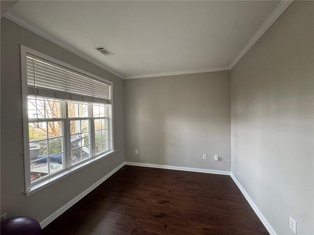 524 King Street Suwanee, GA 30024 - Photo 4 of 23 a view of an empty room with wooden floor and a window