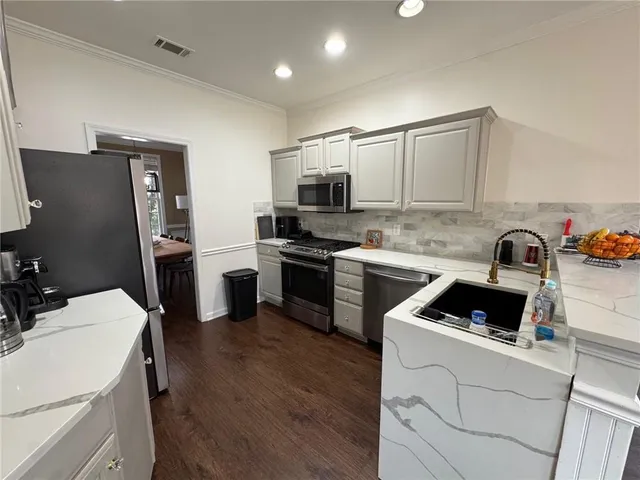 a kitchen with a sink a stove and refrigerator