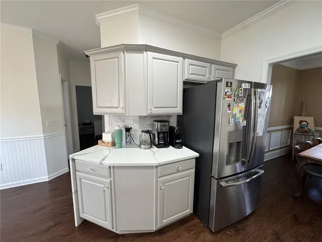 a kitchen with a refrigerator and a stove top oven
