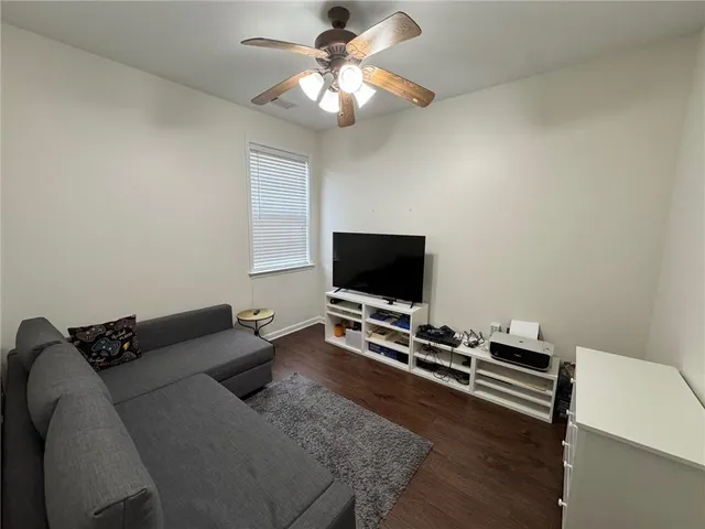 a bedroom with furniture and a flat screen tv