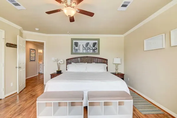 a bedroom with a bed and a flat tv screen on dresser
