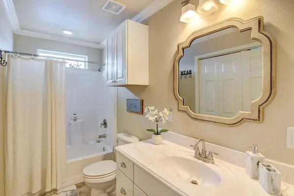 a view of a bathroom with washing machine and a chandelier
