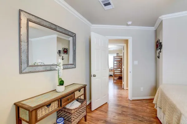 a bedroom with furniture and wooden floor