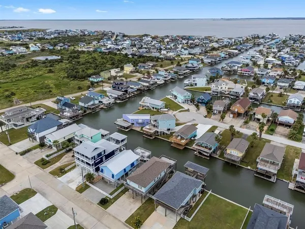 an aerial view of houses with swimming pool