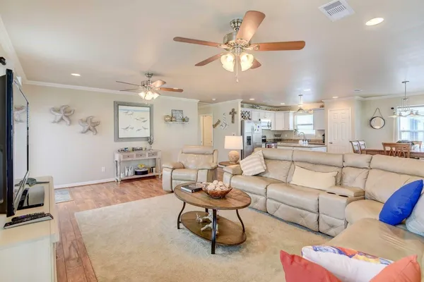 a living room with furniture and wooden floor