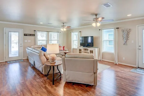 a kitchen with stainless steel appliances kitchen island granite countertop a table chairs and a refrigerator