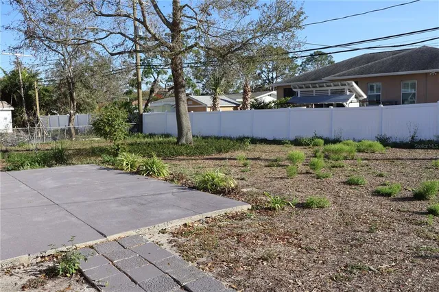 a backyard of a house with a yard and garage