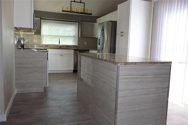 a kitchen with stainless steel appliances granite countertop a sink and cabinets