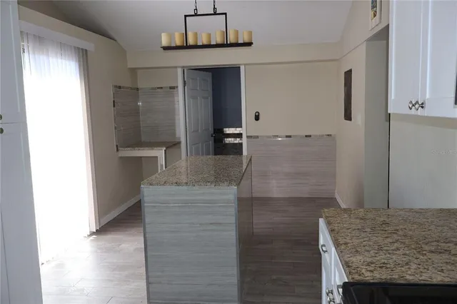a bathroom with a granite countertop sink and shower
