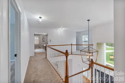 a spacious bedroom with a bed and a dresser