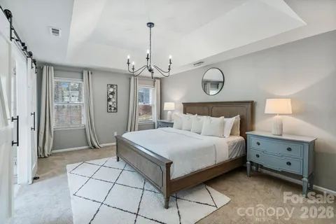a spacious bedroom with a bed and a table