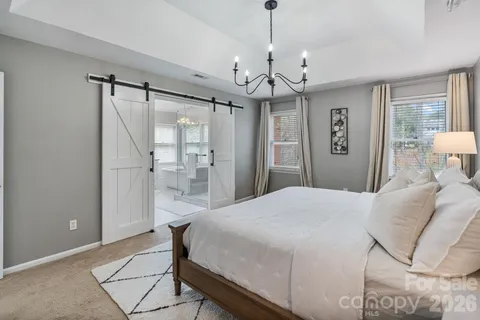 a spacious bathroom with a tub shower and windows