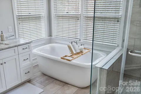 a bedroom with furniture and a large window