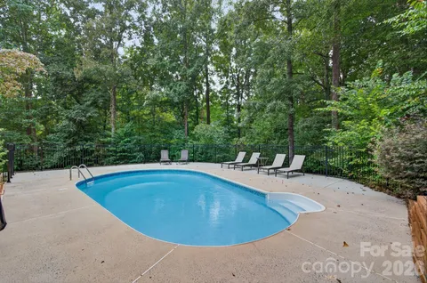 a green field with trees in the background