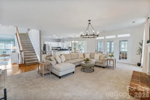 a living room with furniture and a chandelier