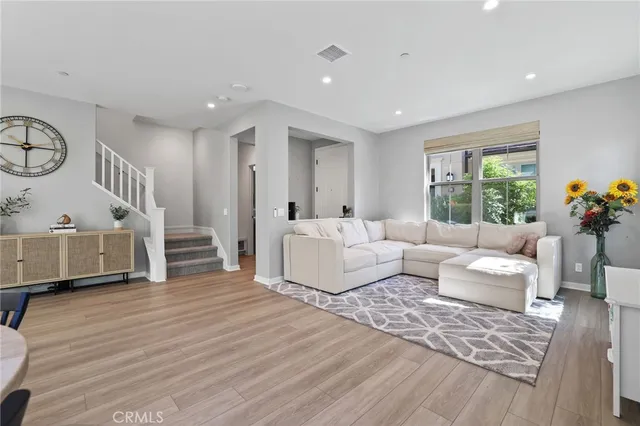 a dining room with furniture and wooden floor