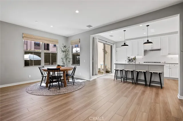 a kitchen with appliances cabinets and wooden floor