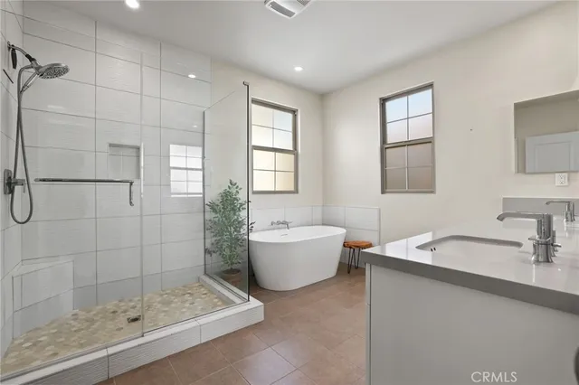 a bedroom with furniture and a potted plant