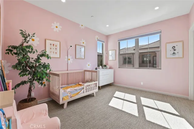 a view of a backyard with couches table and chairs under an umbrella