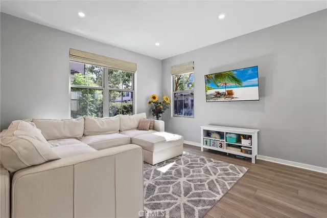 a living room with furniture and wooden floor