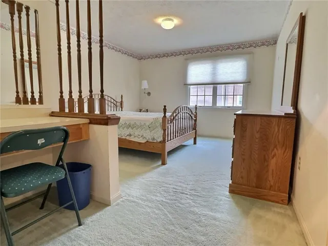 a bedroom with furniture and a window