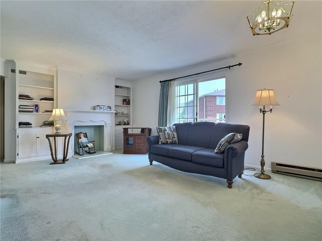 830 South Main Street, Unit 206 Washington, PA 15301 - Photo 5 of 19 a living room with furniture and a chandelier