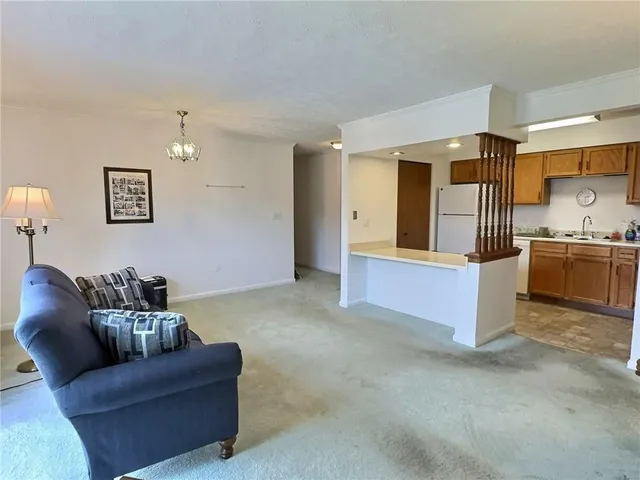 a living room with furniture and a kitchen
