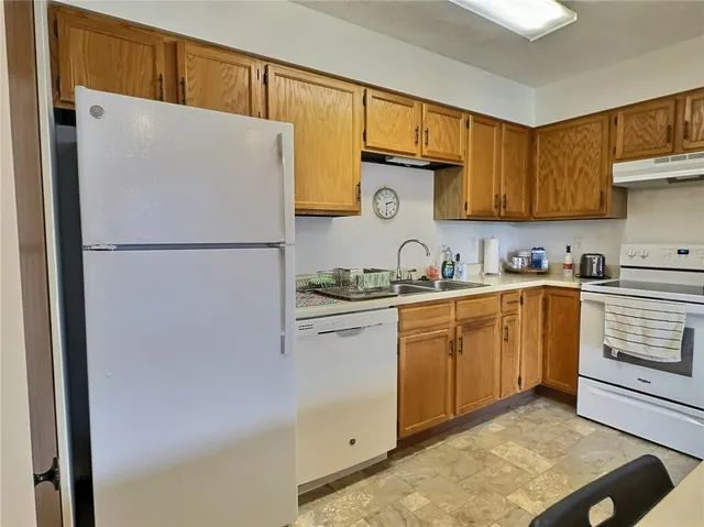 a kitchen with a refrigerator and a sink