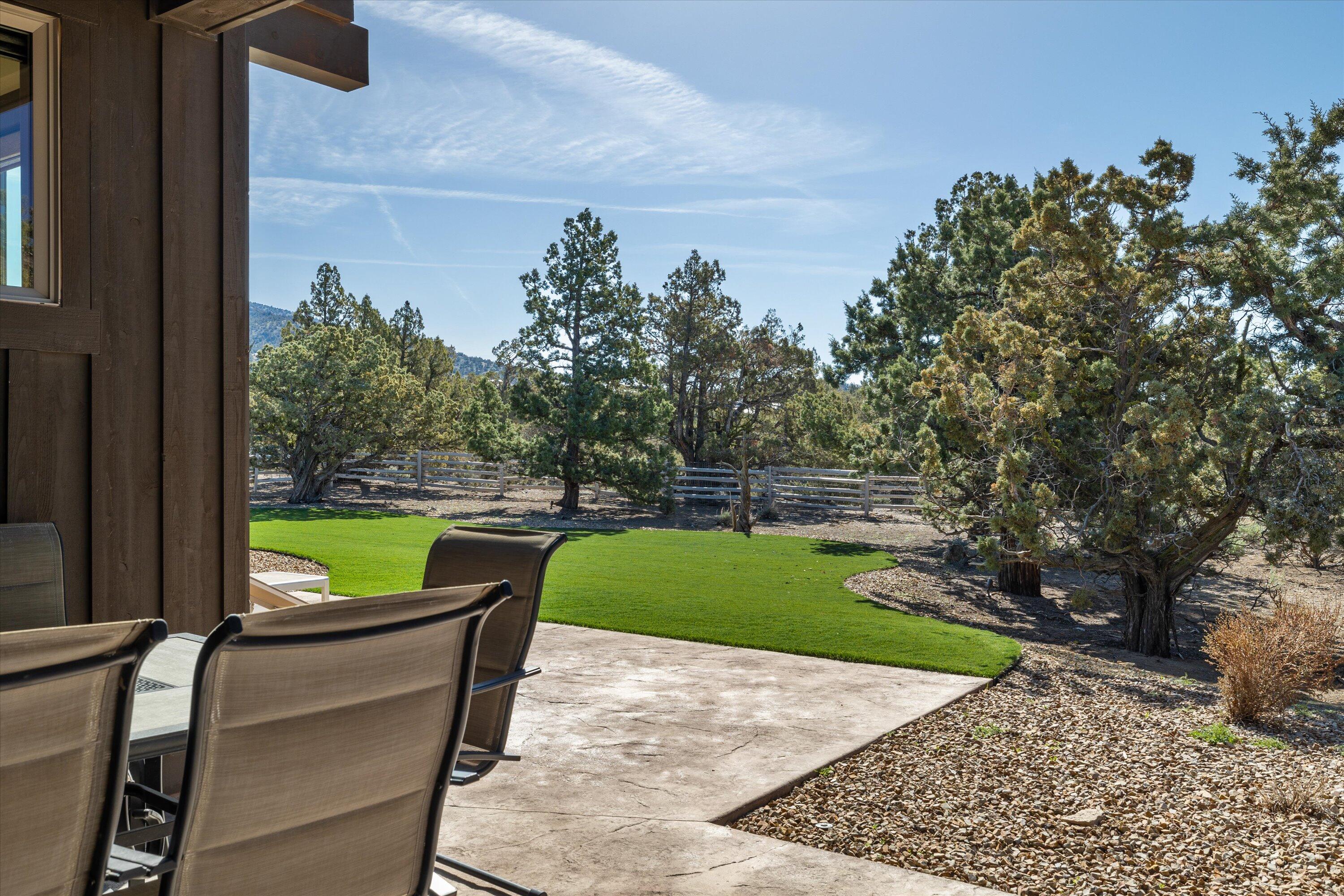 15687 Southwest Brasada Rnch Road Powell Butte, OR 97753 - Photo 56 of 73 a view of a porch with furniture and a yard