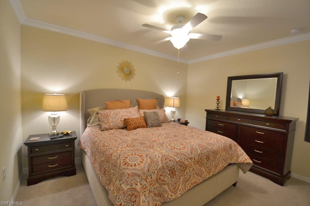 9560 Trevi Court, Unit 4816 Naples, FL 34113 - Photo 11 of 31 a bedroom with a bed and a flat screen tv