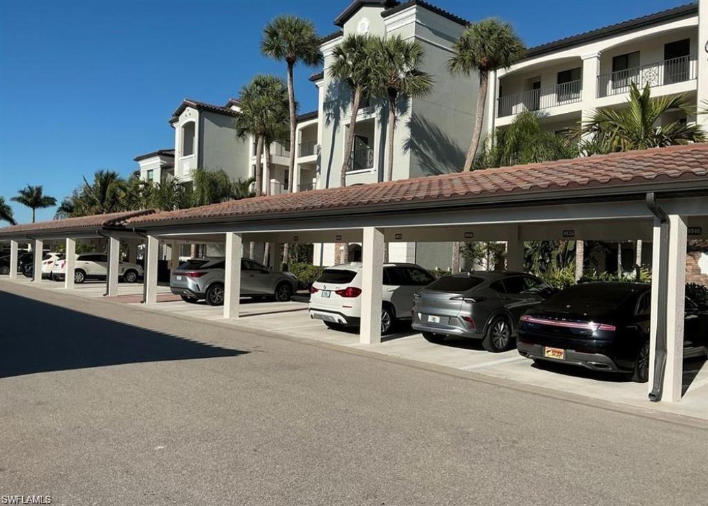 9560 Trevi Court, Unit 4816 Naples, FL 34113 - Photo 2 of 31 a view of a car park in front of house