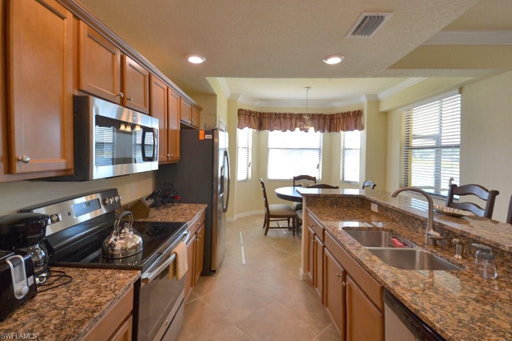 9560 Trevi Court, Unit 4816 Naples, FL 34113 - Photo 9 of 31 a kitchen with granite countertop lots of counter top space