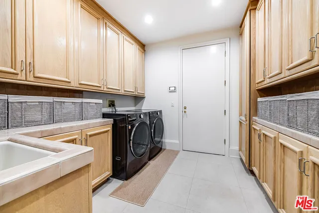 a view of a white house with a yard and plants