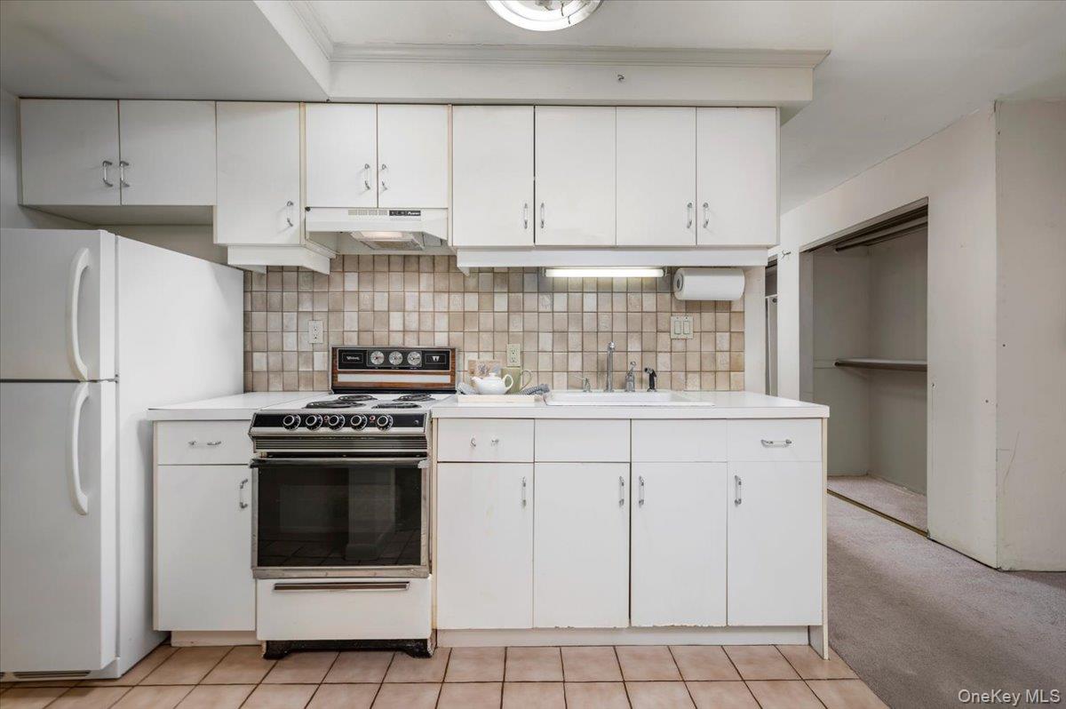 580 Bedford Road, Unit 8 Pleasantville, NY 10570 - Photo 11 of 35 a kitchen with white cabinets and white appliances