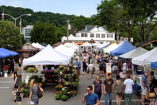 a view of a roof deck with table and chairs with wooden floor and fence