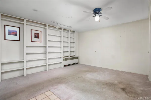 a view of room with balcony and a ceiling fan